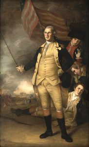 A painting, it shows George Washington in the center, with the American Flag behind him and three men. Hugh Mercer is the man in the top left, with a hat on and a red jacket.